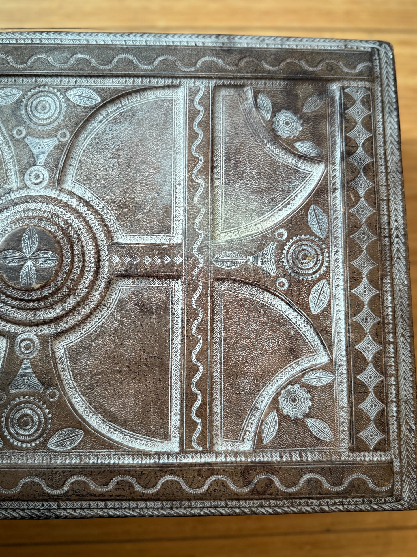 Decorative leather box with intricate patterns on the surface